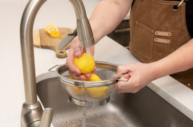 washing lemons in sink