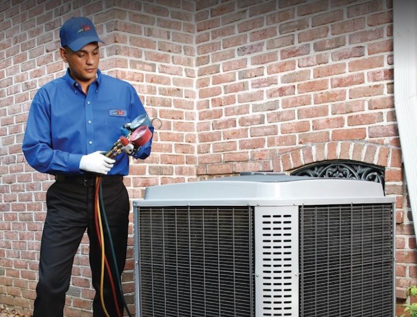 ARS Technician performing HVAC maintenance on residential system.