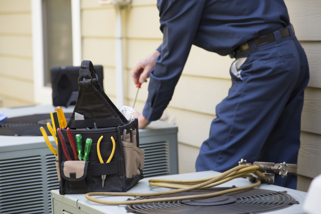 Repairman fixing AC unit