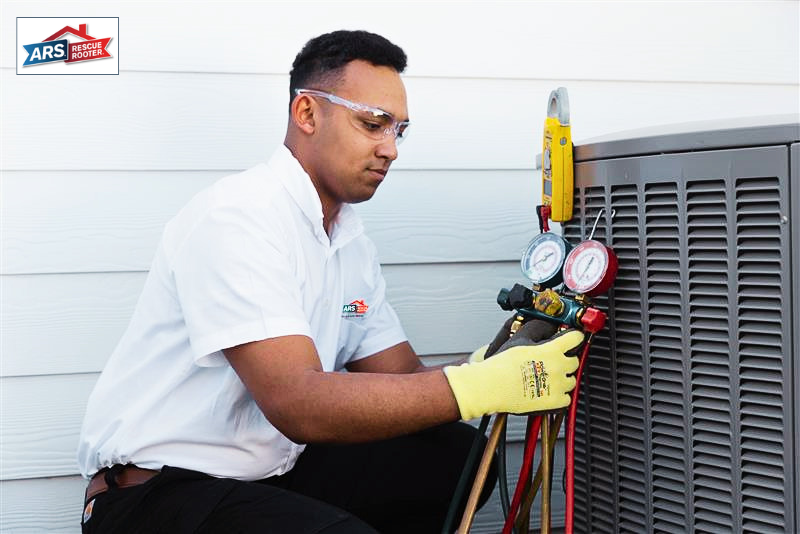ARS professional outside a home, holding an inspection testing tool attached to an air conditioning unit, providing AC maintenance service.