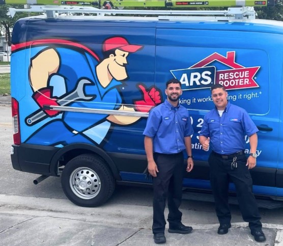 ARS Rescue Rooter technicians in front of van, providing HVAC and plumbing services in Forest Hill, MD.