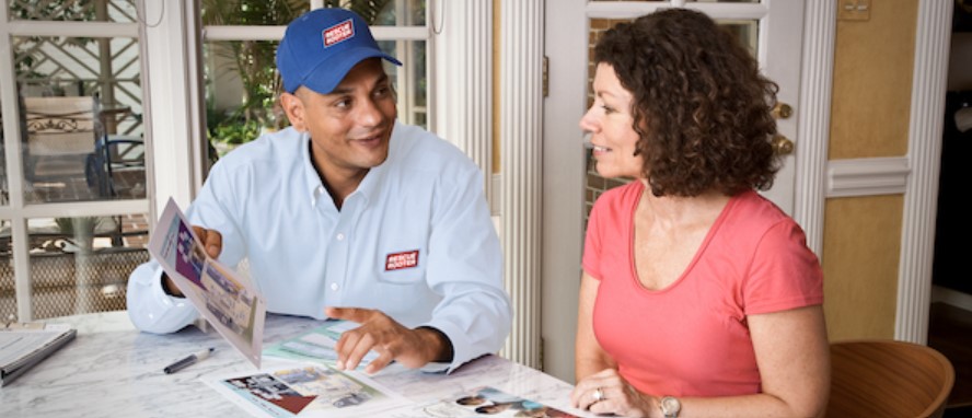 Technician guiding customer about how to care for her HVAC system